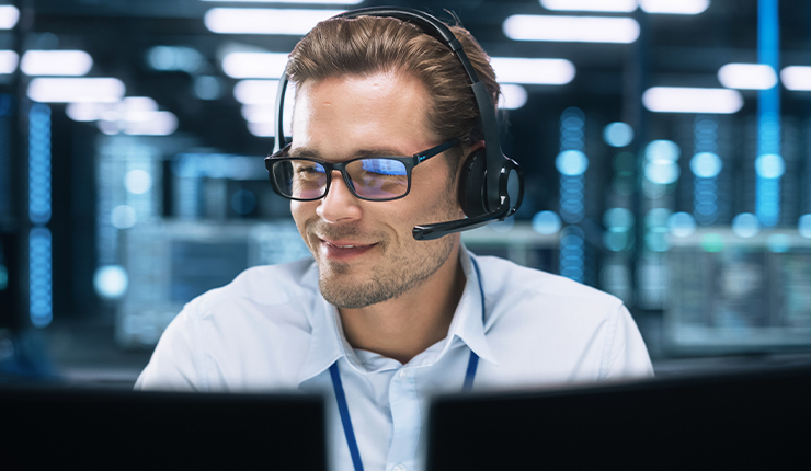 man looking at two monitors