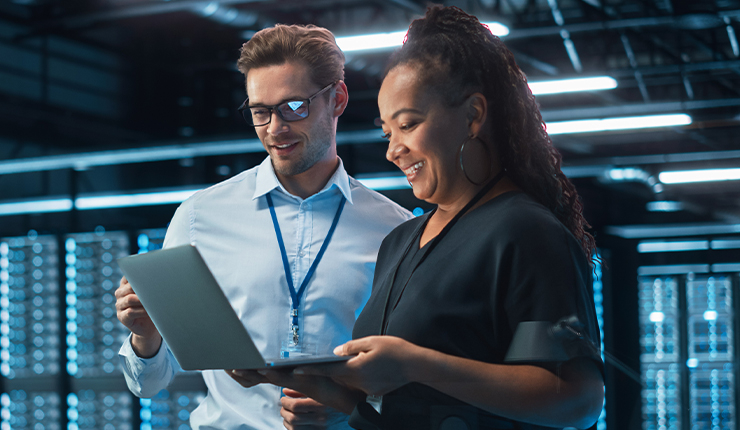 two people looking at a laptop